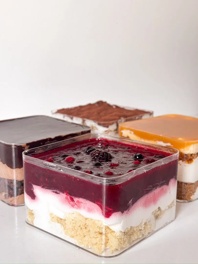 Slices of assorted entremets: raspberry, tiramisu and mango