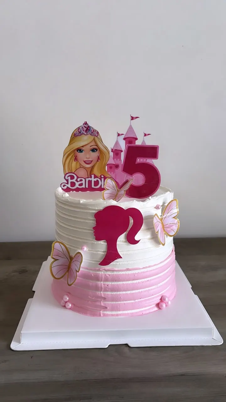 Pink and white Barbie-themed birthday cake with the number 5 and butterflies