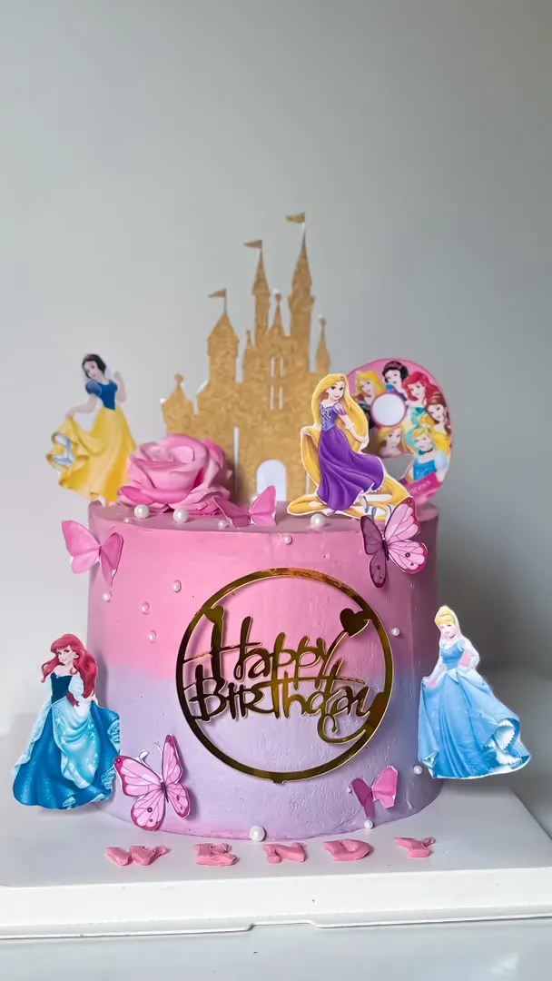 Pink princess-themed cake with a castle backdrop and figurines