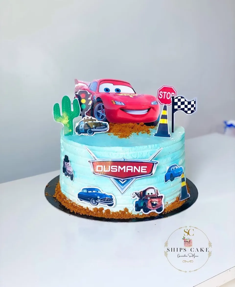 Pale blue Cars cake with the red racing car, a cactus and a chequered flag