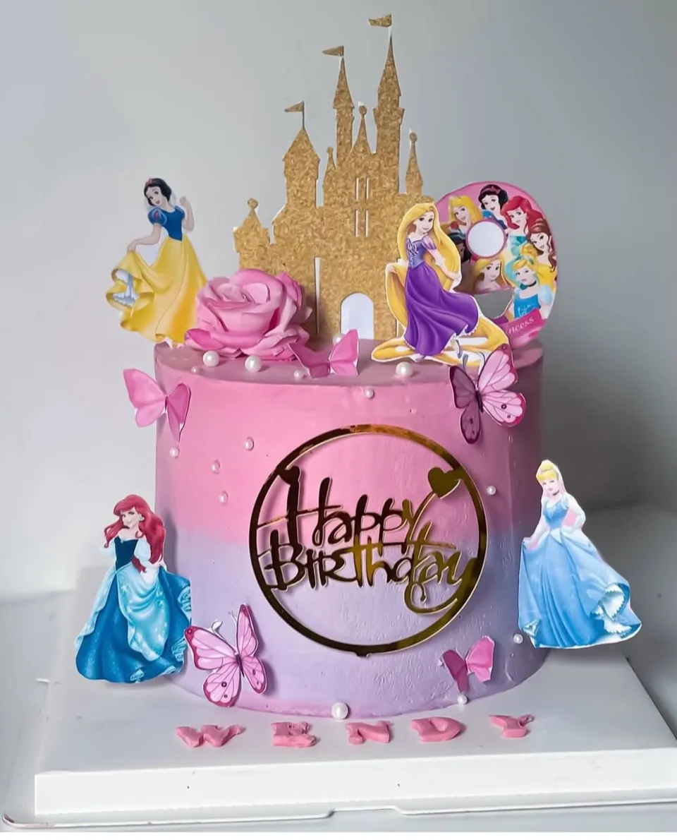 Pink and mauve ombre cake on the Disney princesses theme, with a gold castle