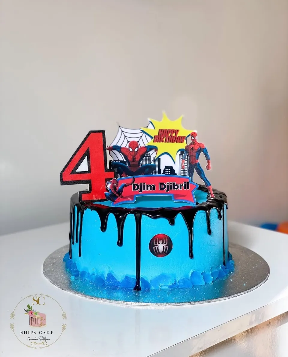 Blue cake with a dark chocolate drip on the Spider-Man theme, with a figurine